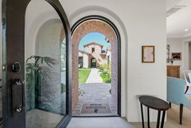 a living room with fireplace furniture and a large window