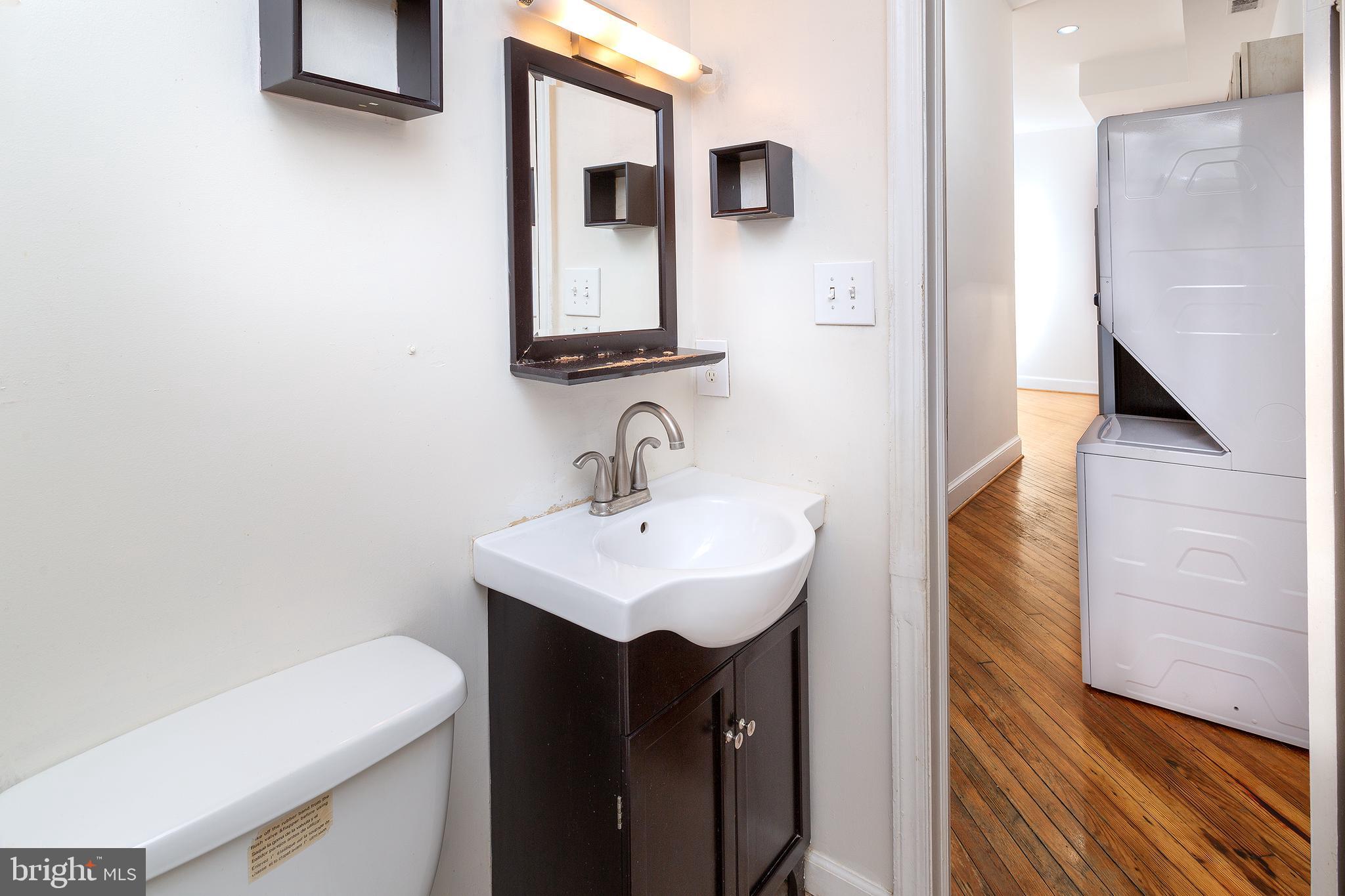 1213 12th Street Northwest, Unit A Washington, DC 20005 - Photo 14 of 25 a bathroom with a sink and a mirror
