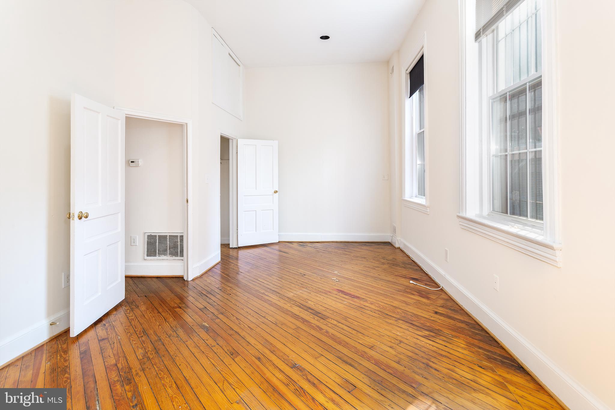 1213 12th Street Northwest, Unit A Washington, DC 20005 - Photo 17 of 25 a view of an empty room with wooden floor and a window