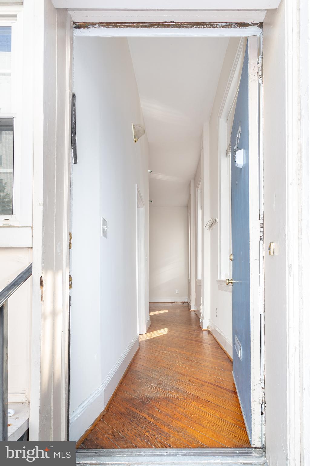 1213 12th Street Northwest, Unit A Washington, DC 20005 - Photo 5 of 25 a view of a hallway with wooden floor and a bathroom