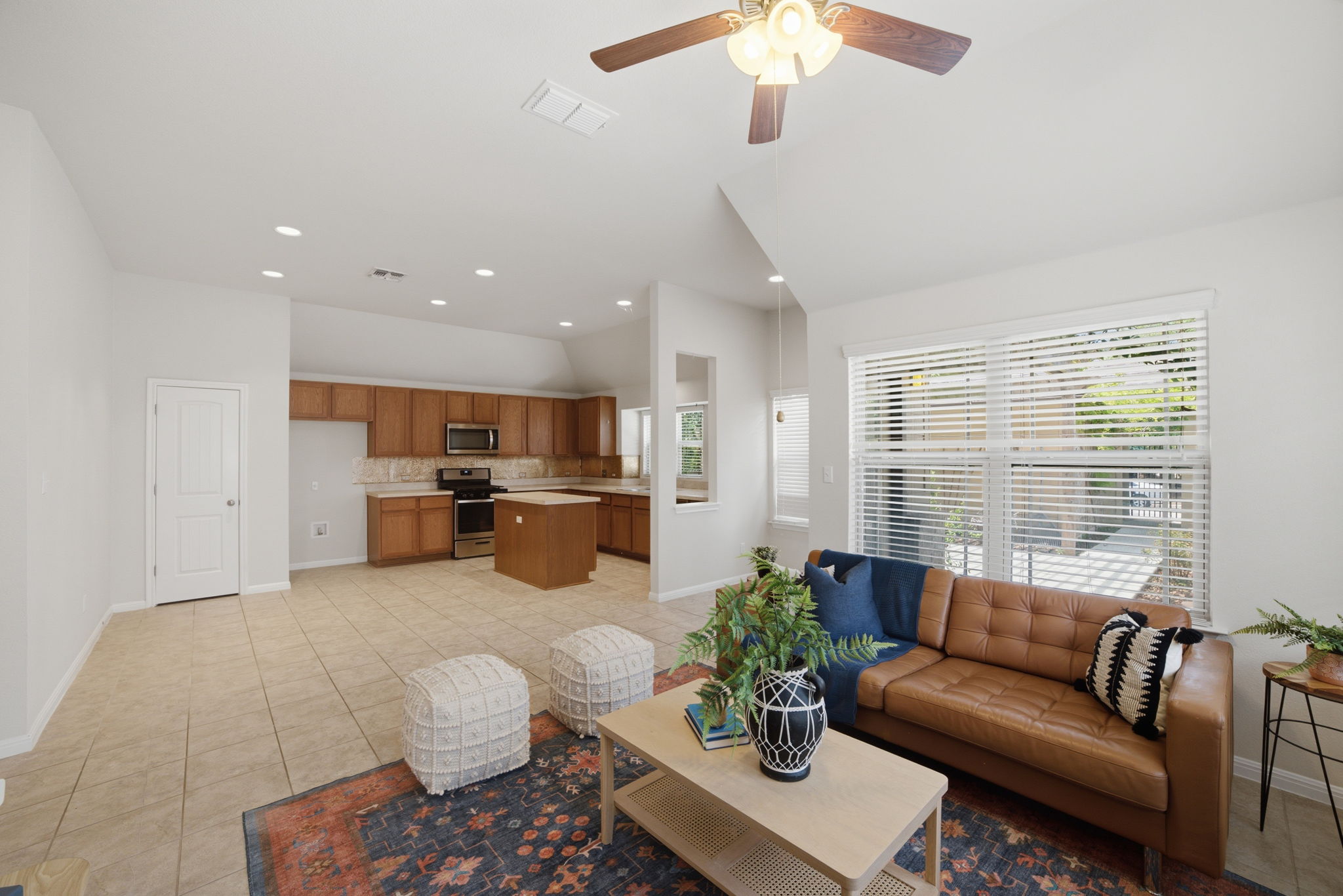 514 Nautical Loop Kyle, TX 78640 - Photo 8 of 24 An open concept living area transitions fluidly into a functional kitchen, bathed in natural light.
