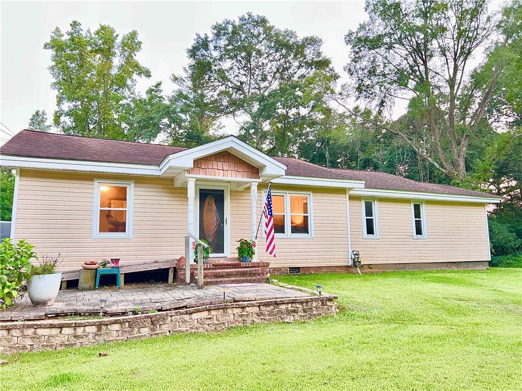 a front view of house with yard and green space