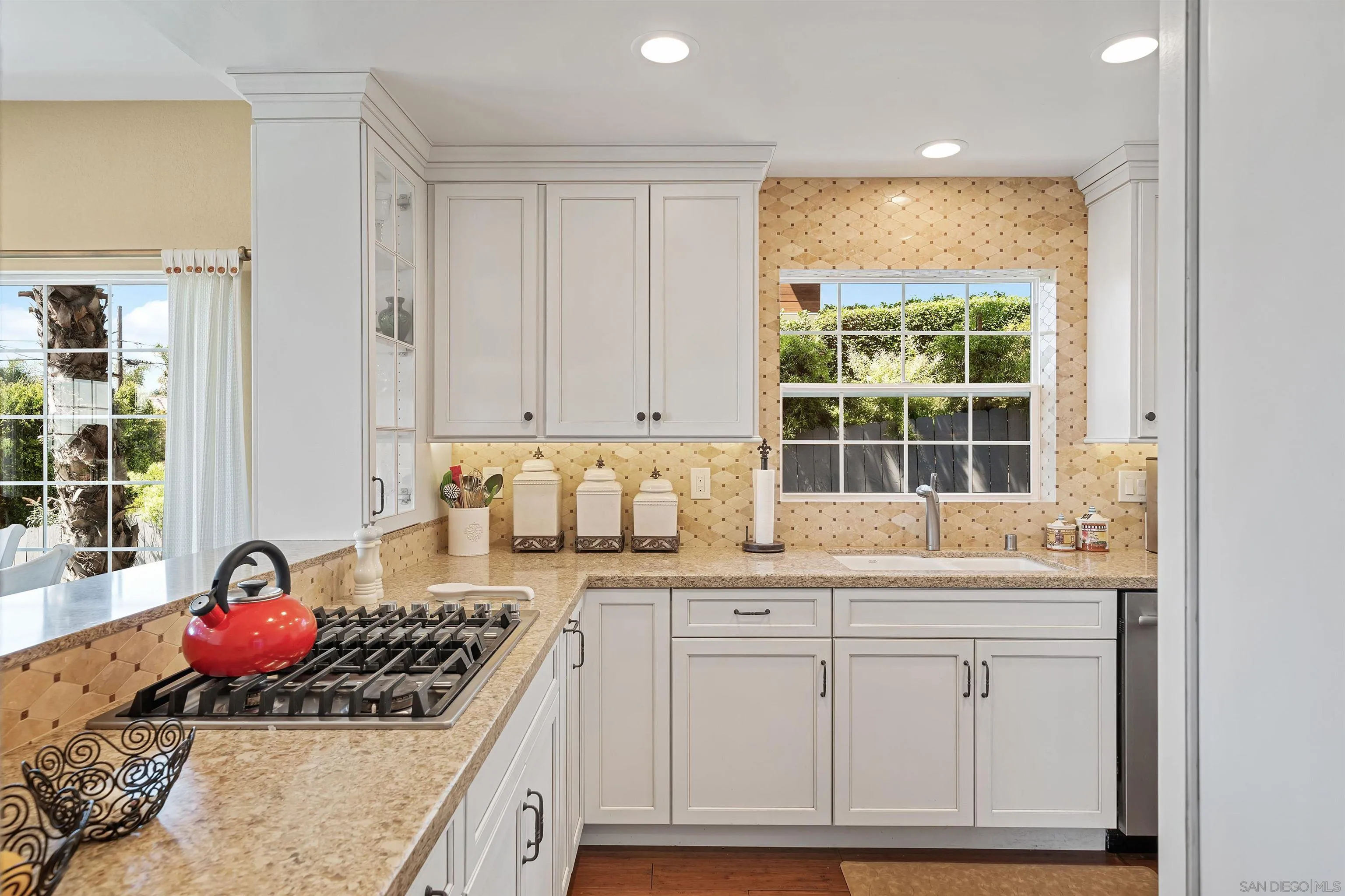 822 Ida Avenue Solana Beach, CA 92075 - Photo 15 of 34 a kitchen with granite countertop a stove a sink and white cabinets