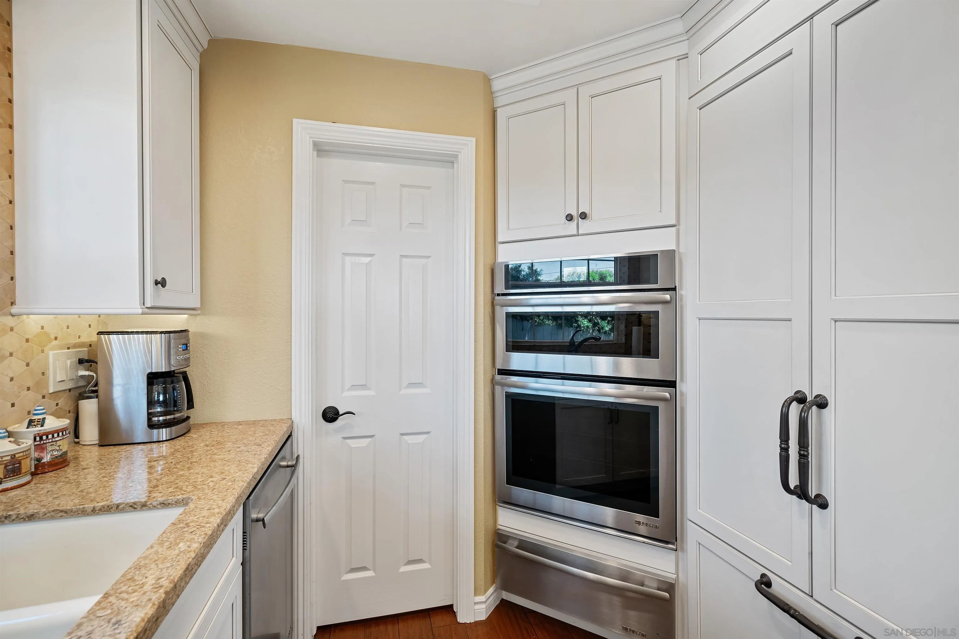 822 Ida Avenue Solana Beach, CA 92075 - Photo 17 of 34 a kitchen with granite countertop white cabinets and white appliances