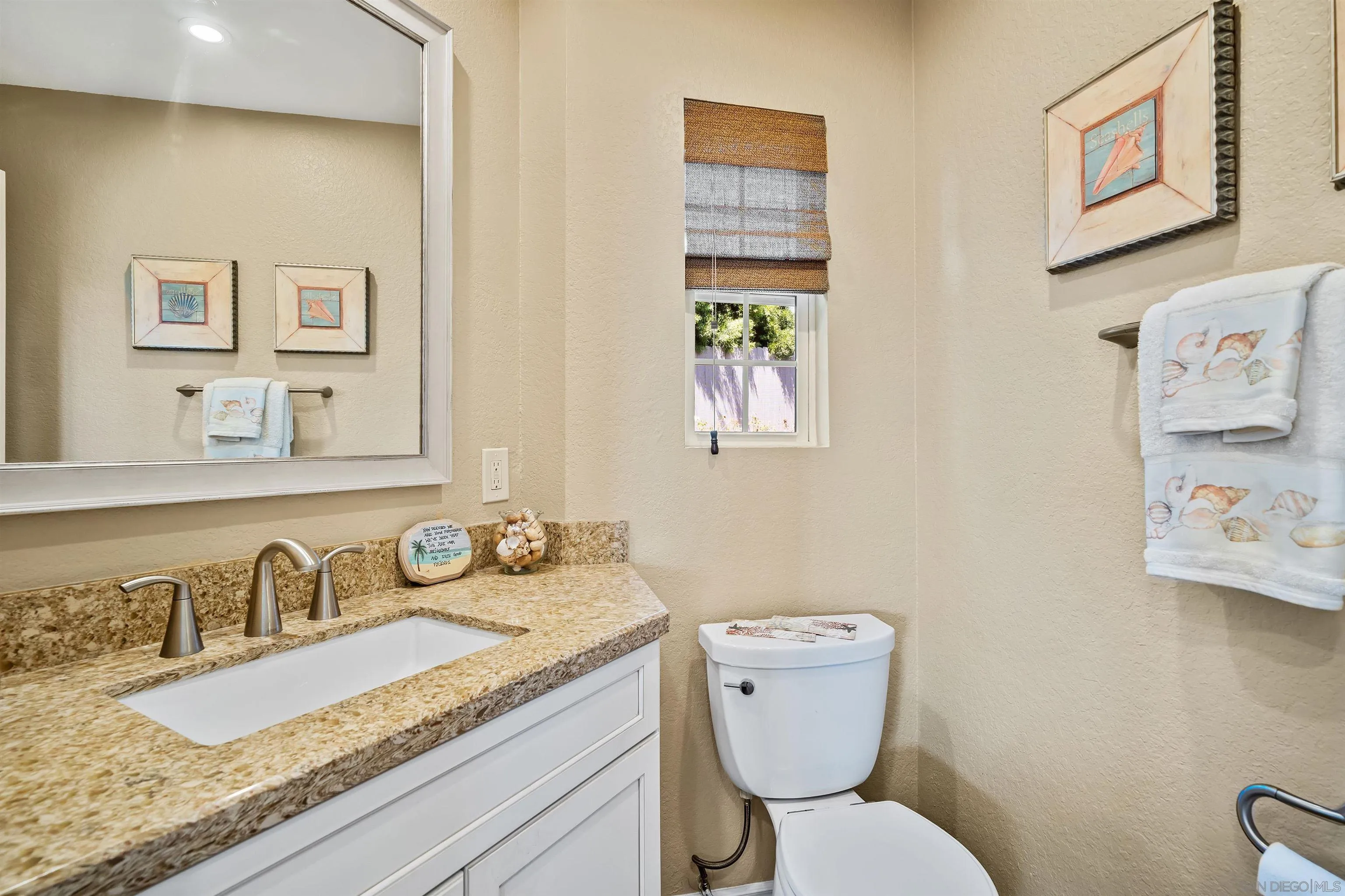 822 Ida Avenue Solana Beach, CA 92075 - Photo 18 of 34 a bathroom with a granite countertop toilet sink and mirror
