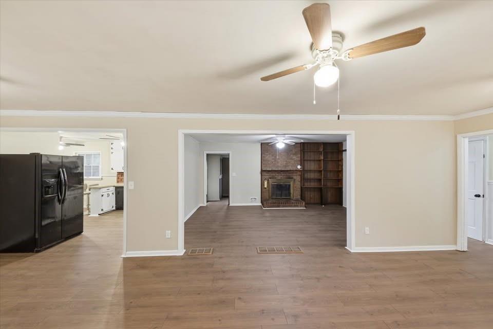 8435 Campbellton Fairburn Road Fairburn, GA 30213 - Photo 6 of 21 a view of a livingroom with a chandelier fan and a kitchen