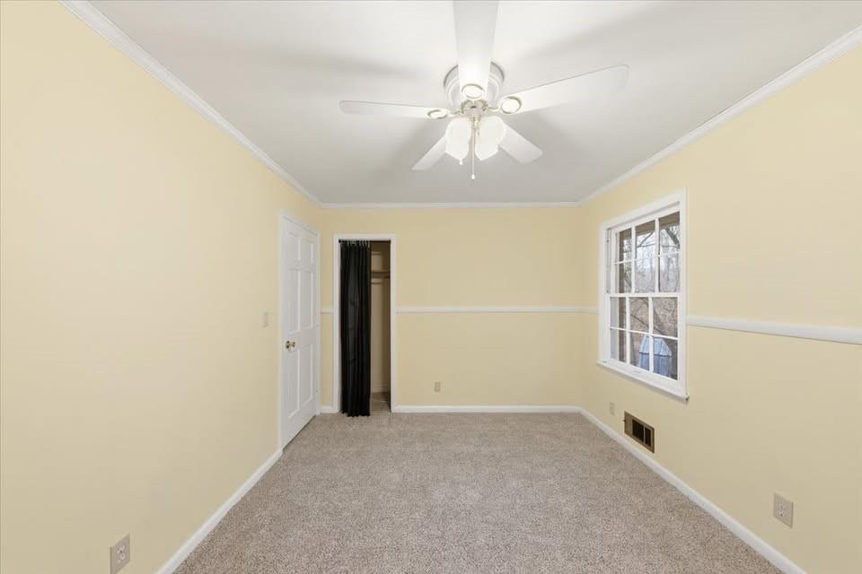 8435 Campbellton Fairburn Road Fairburn, GA 30213 - Photo 8 of 21 an empty room with chandelier fan and windows