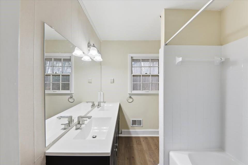 8435 Campbellton Fairburn Road Fairburn, GA 30213 - Photo 10 of 21 a bathroom with a sink a tub and a mirror