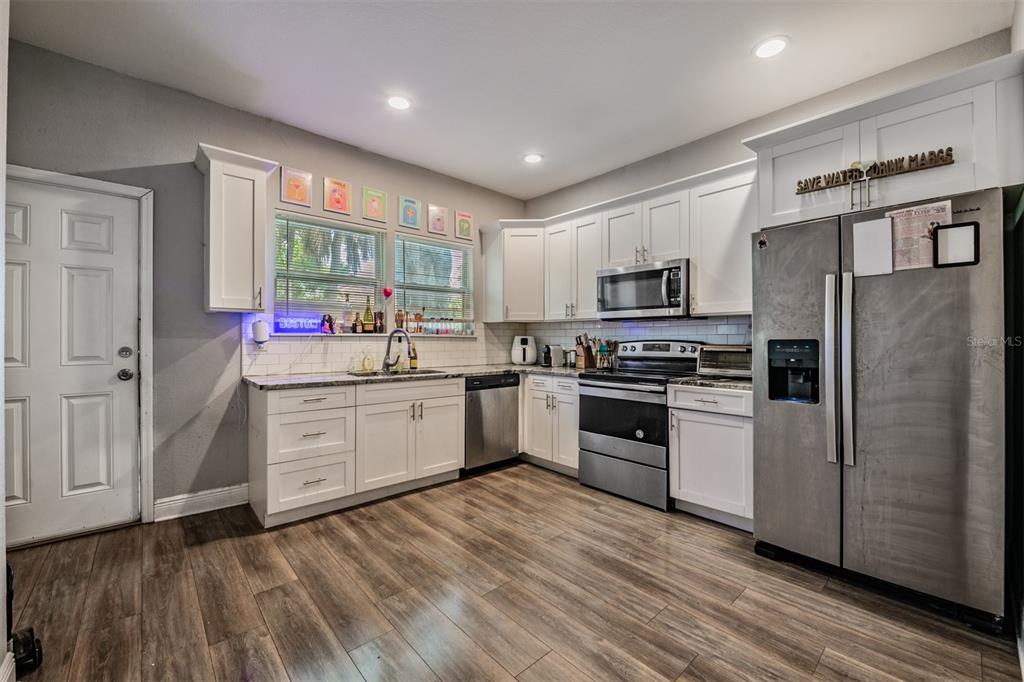 2334 West Spruce Street Tampa, FL 33607 - Photo 11 of 24 a kitchen with stainless steel appliances a refrigerator sink and microwave