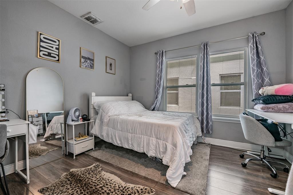 2334 West Spruce Street Tampa, FL 33607 - Photo 15 of 24 a bedroom with a bed a desk and chair