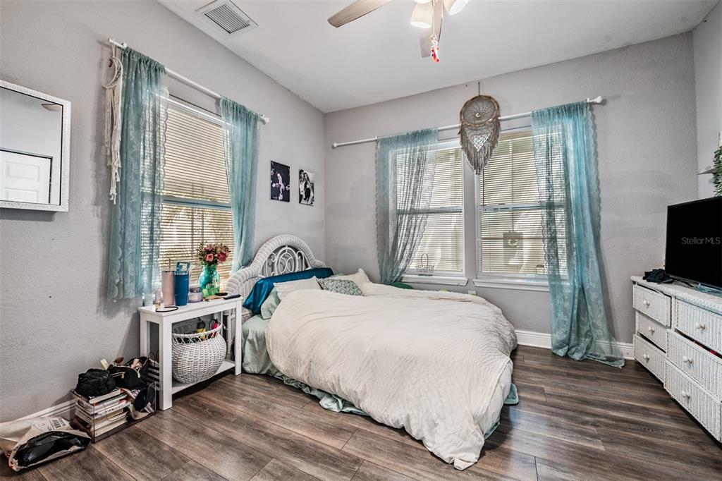 2334 West Spruce Street Tampa, FL 33607 - Photo 17 of 24 a bedroom with a bed and a flat tv screen on dresser