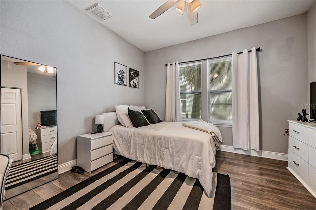 2334 West Spruce Street Tampa, FL 33607 - Photo 19 of 24 a bedroom with a bed and wooden floor