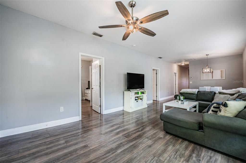 2334 West Spruce Street Tampa, FL 33607 - Photo 7 of 24 a living room with furniture a ceiling fan and a wooden floor