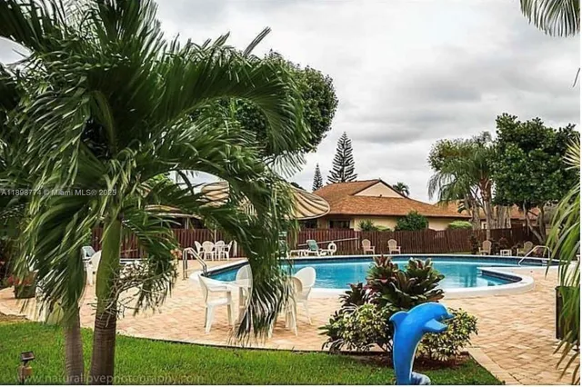 a view of a house with swimming pool and sitting area