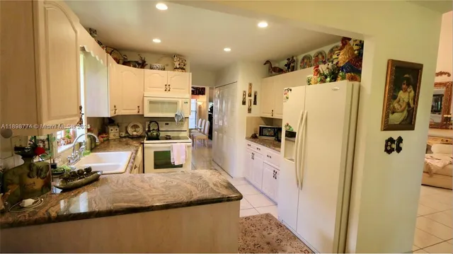 a kitchen with stainless steel appliances a refrigerator sink and stove