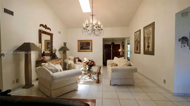 a living room with furniture and a chandelier