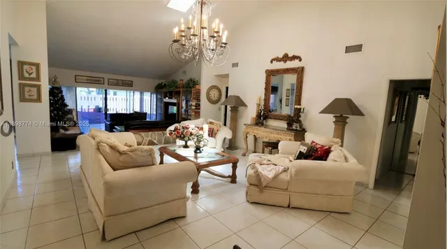 a living room with furniture and a chandelier
