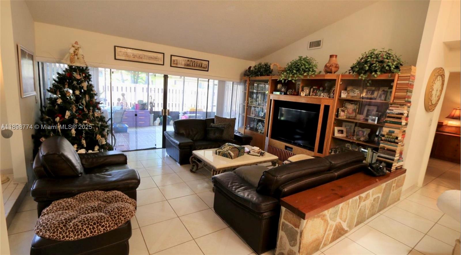 7521 Southwest 26th Court, Unit 77 Davie, FL 33314 - Photo 6 of 13 a living room with furniture a flat screen tv and a fireplace