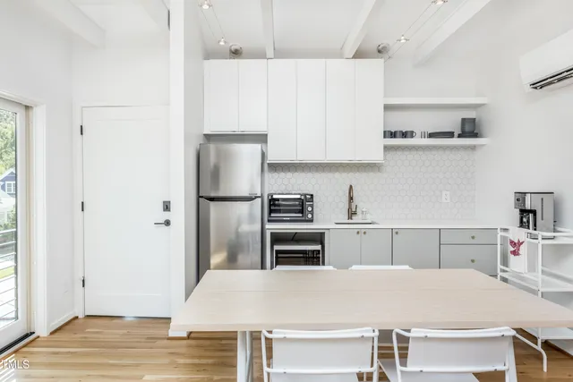 a kitchen with stainless steel appliances a stove refrigerator sink and cabinets