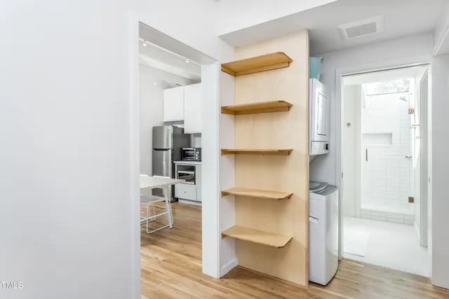 a bathroom with a walk in closet and a mirror