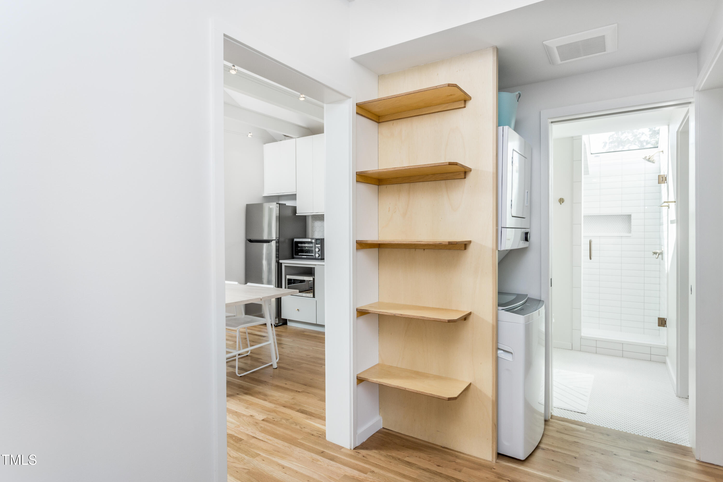 123 Idlewild Avenue, Unit 301 Raleigh, NC 27601 - Photo 14 of 20 a bathroom with a walk in closet and a mirror