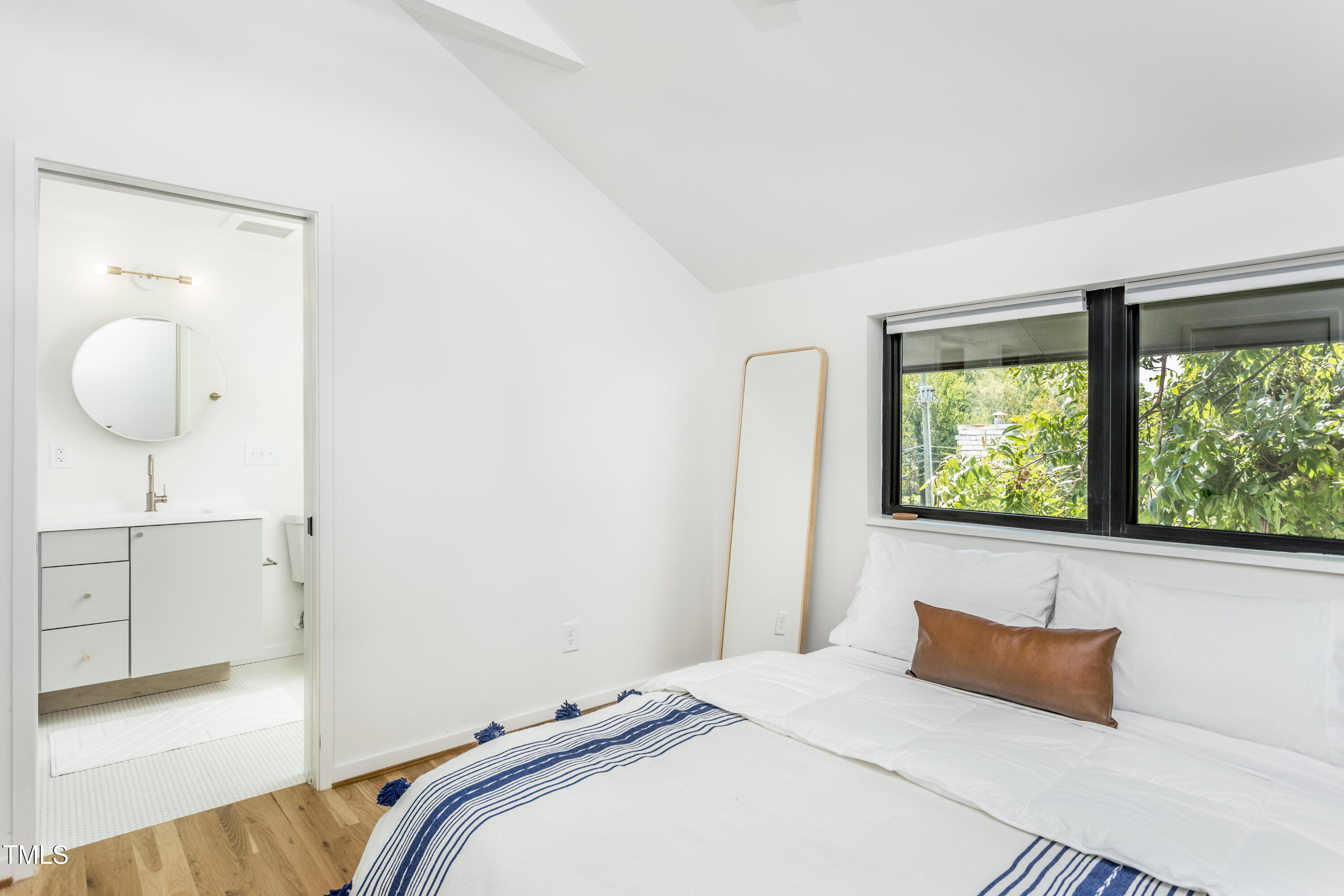 123 Idlewild Avenue, Unit 301 Raleigh, NC 27601 - Photo 16 of 20 a bedroom with a bed and a large window