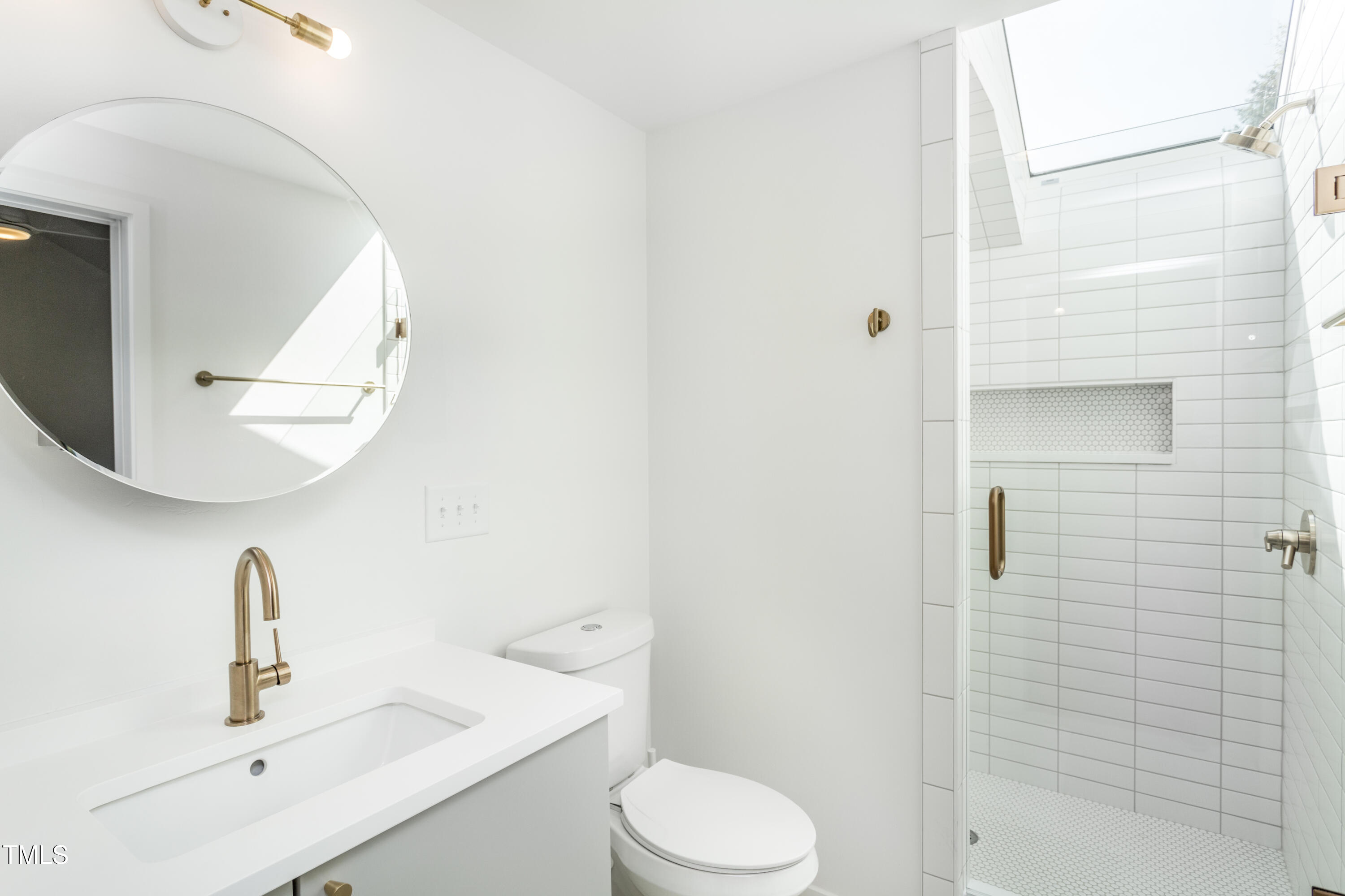 123 Idlewild Avenue, Unit 301 Raleigh, NC 27601 - Photo 17 of 20 a bathroom with a sink a toilet and shower