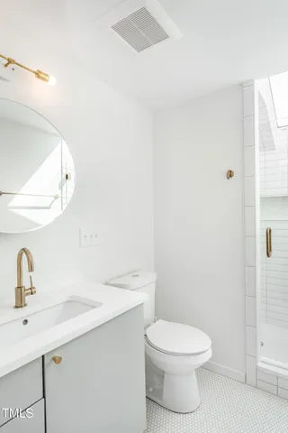 a bathroom with a toilet a sink and mirror