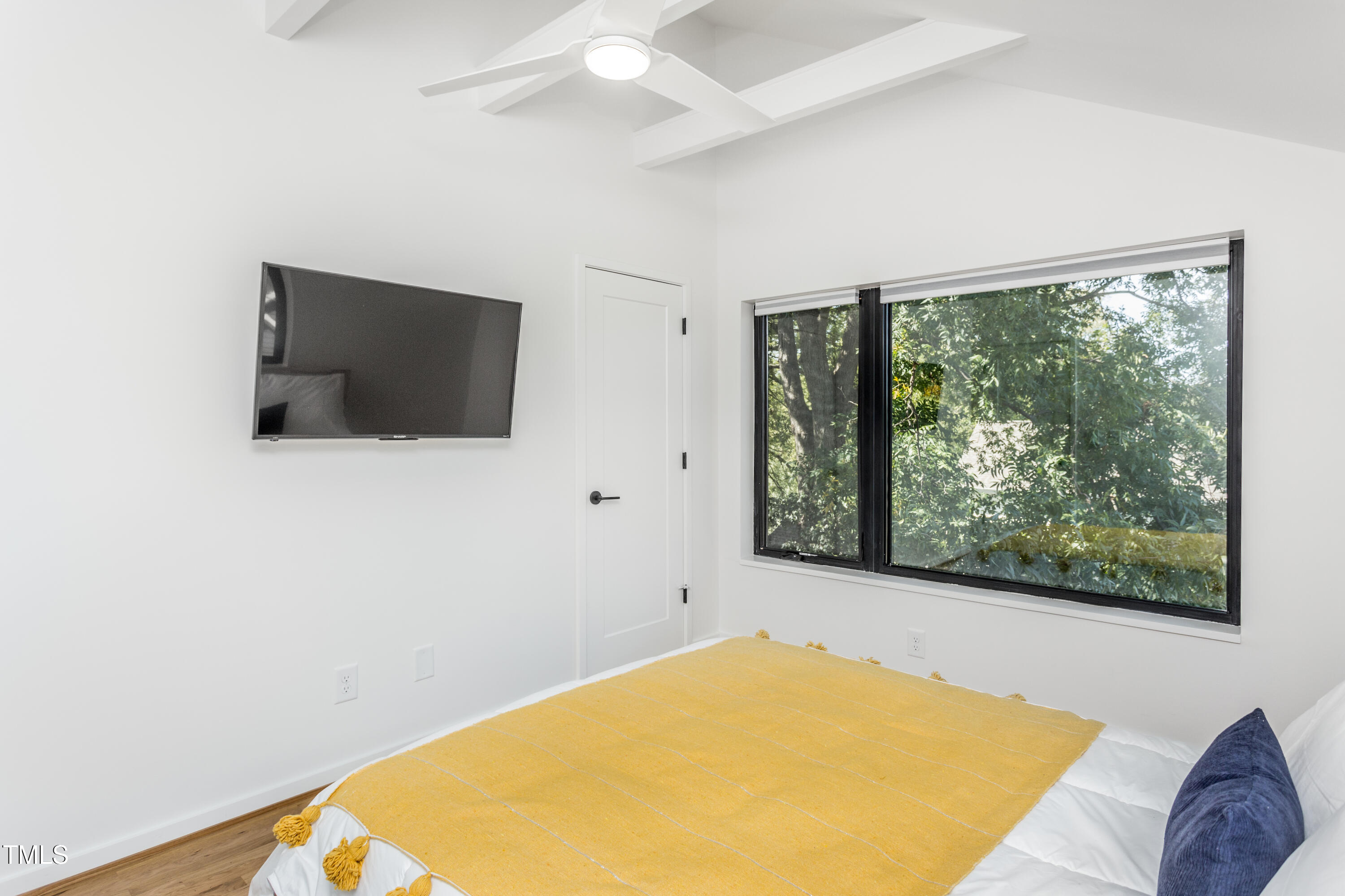 123 Idlewild Avenue, Unit 301 Raleigh, NC 27601 - Photo 20 of 20 a bedroom with a bed and a flat screen tv
