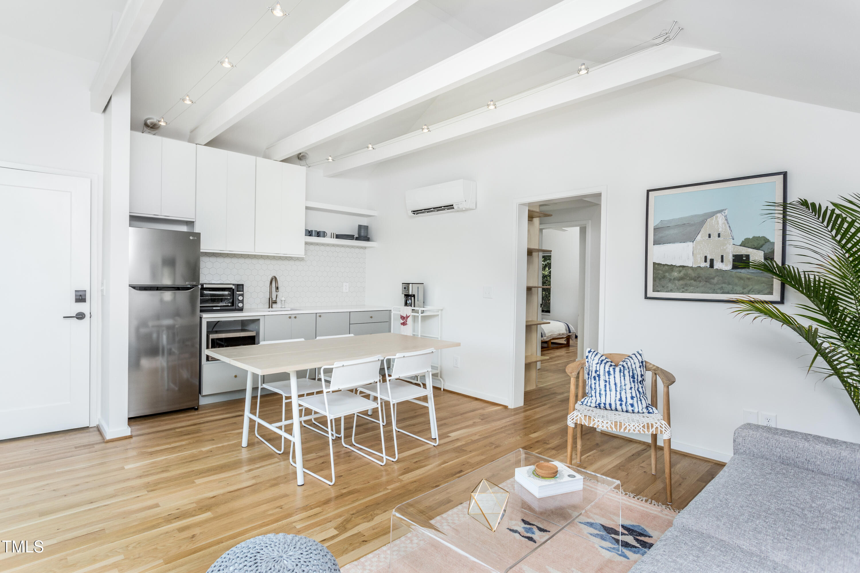 123 Idlewild Avenue, Unit 301 Raleigh, NC 27601 - Photo 10 of 20 a dining room with wooden floor and stainless steel appliances