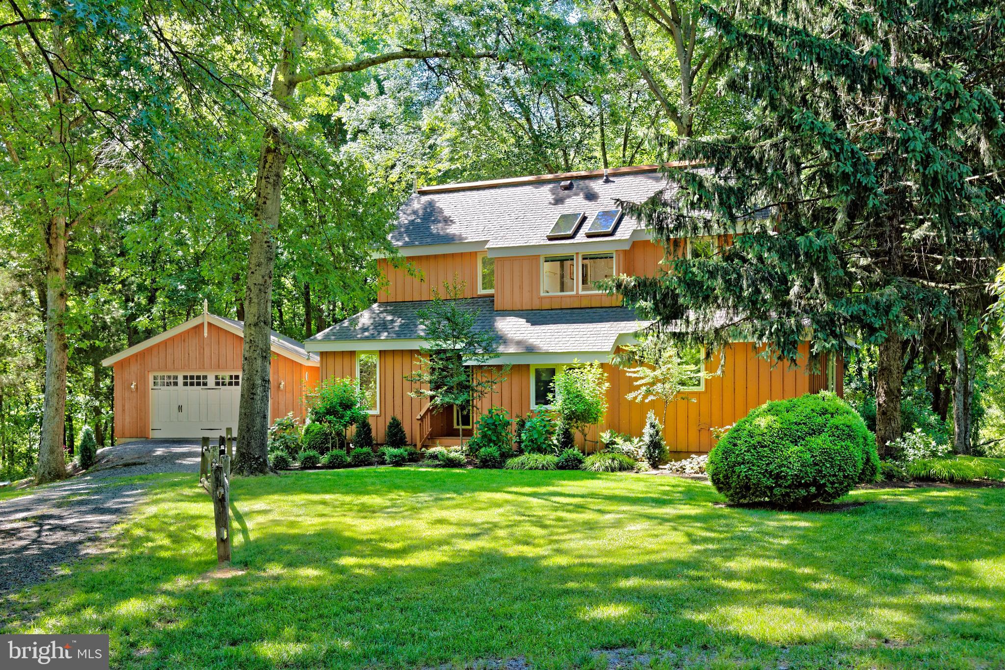 Home surrounded by lawns, mature trees and gardens