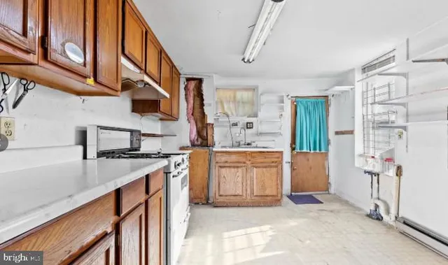 a kitchen with a white cabinets and white appliances
