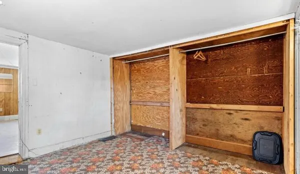 a view of walk in closet with wooden floor