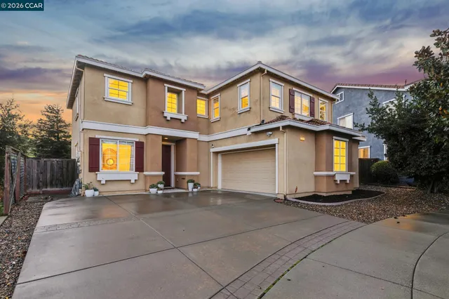 a view of a building with many windows and a yard