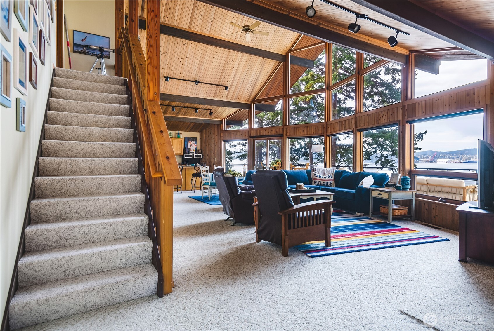 7616 Cypress Way Anacortes, WA 98221 - Photo 11 of 35 a living room with furniture and a floor to ceiling window