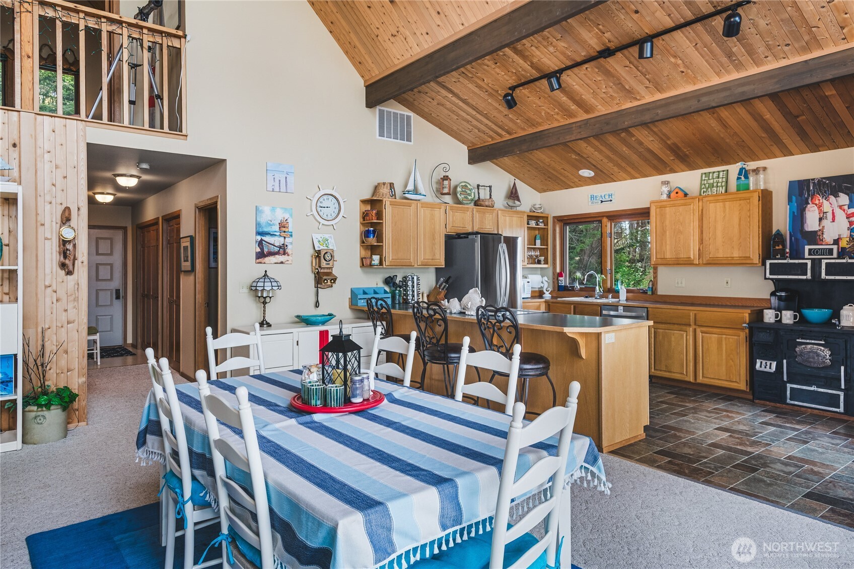 7616 Cypress Way Anacortes, WA 98221 - Photo 18 of 35 a view of a dining room with furniture window and wooden floor