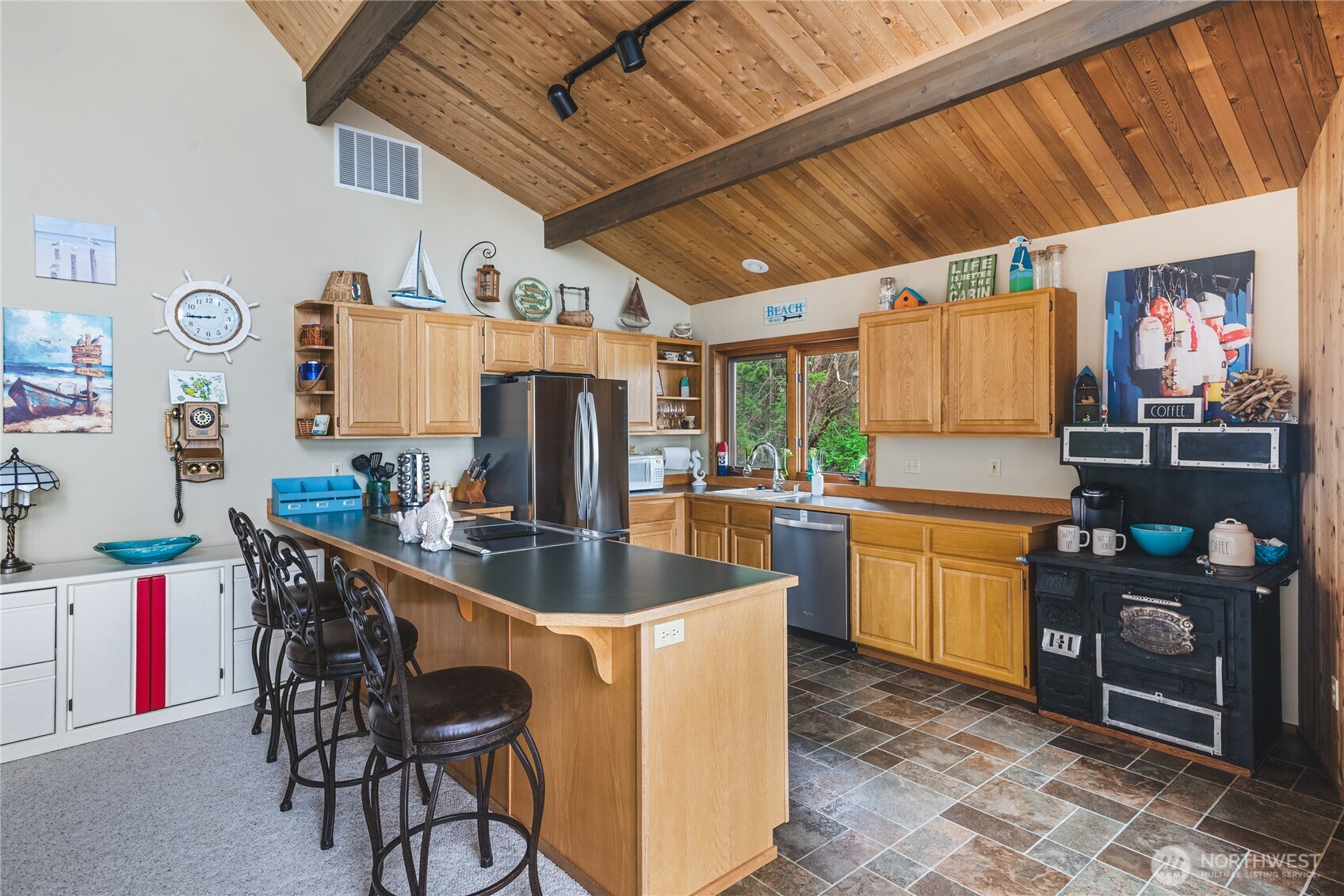 7616 Cypress Way Anacortes, WA 98221 - Photo 20 of 35 a kitchen with stainless steel appliances granite countertop a sink a stove and a refrigerator