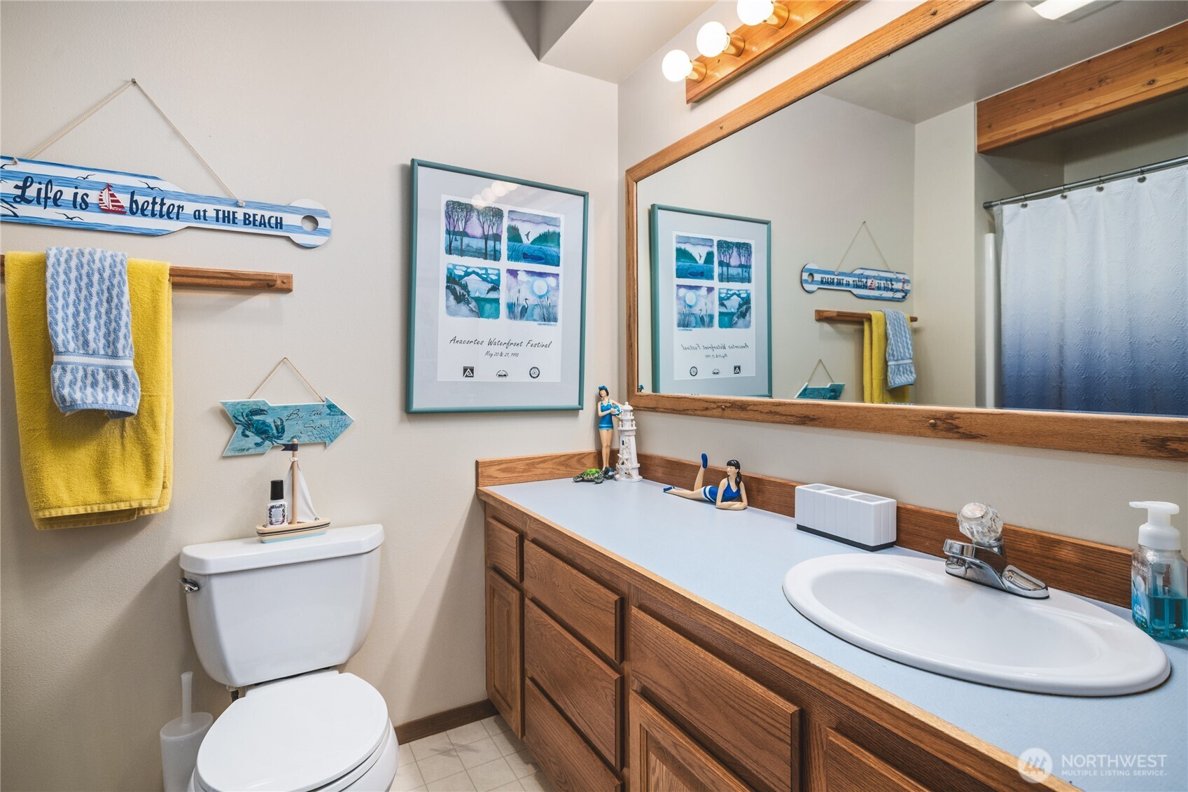 7616 Cypress Way Anacortes, WA 98221 - Photo 24 of 35 a bathroom with a toilet sink and mirror
