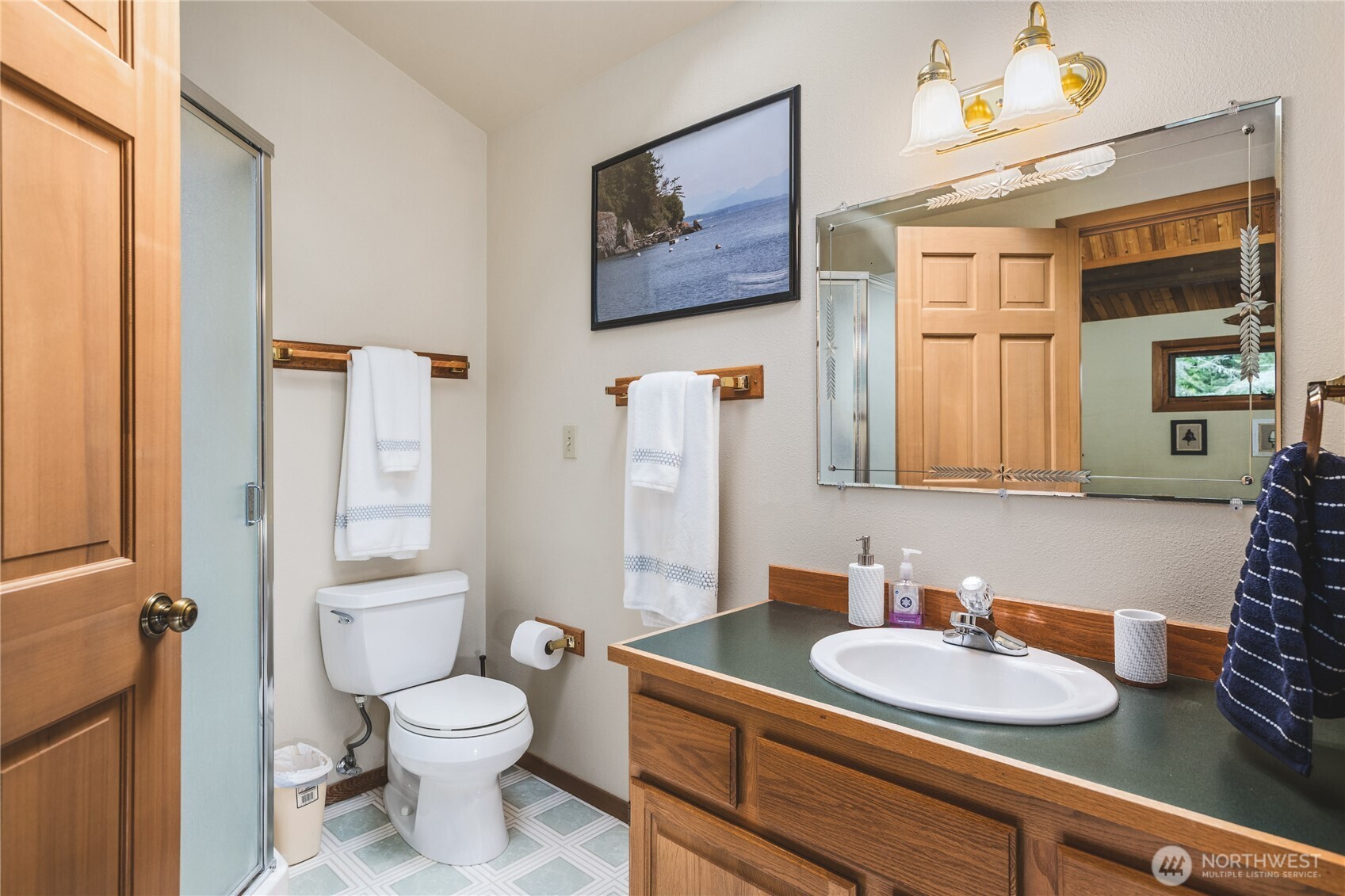 7616 Cypress Way Anacortes, WA 98221 - Photo 29 of 35 a bathroom with a granite countertop sink mirror vanity and toilet