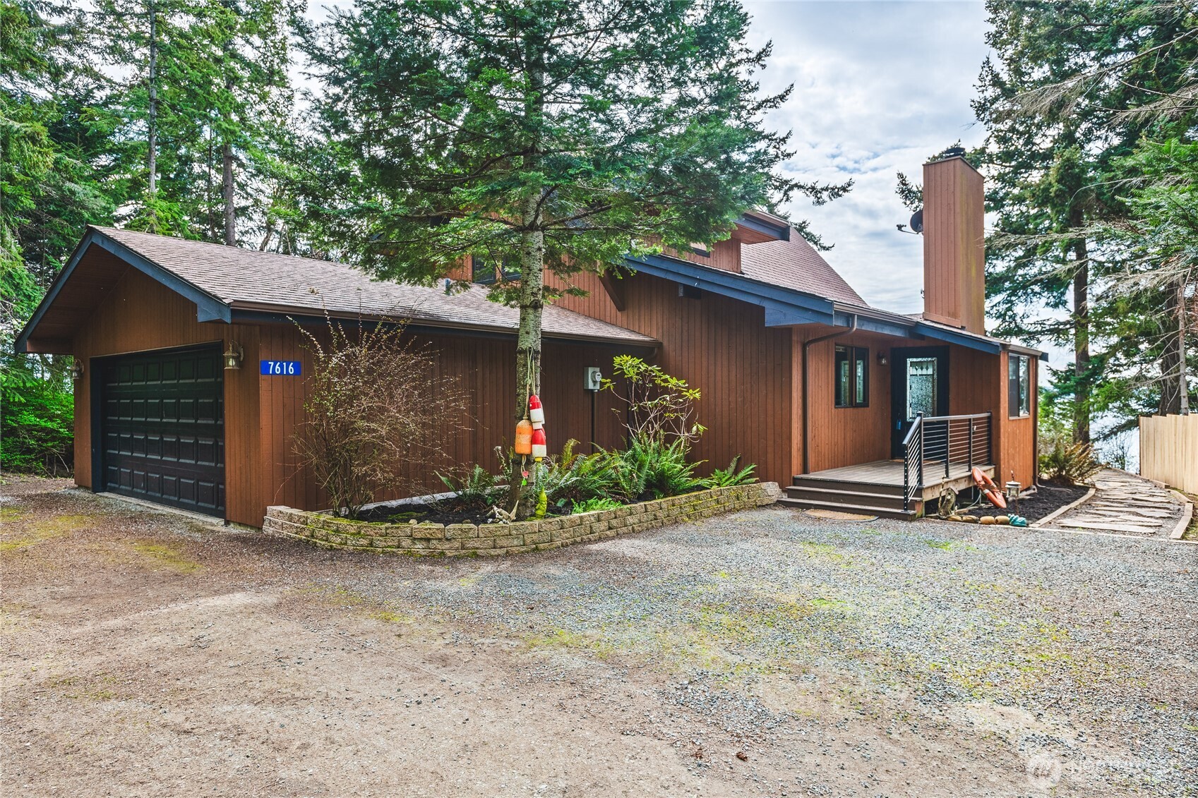 7616 Cypress Way Anacortes, WA 98221 - Photo 8 of 35 a view of a house with backyard and trees