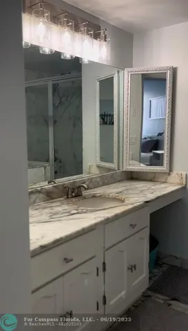 a bathroom with a sink and mirror