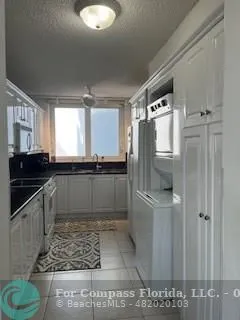 a kitchen with stainless steel appliances granite countertop a sink and a stove