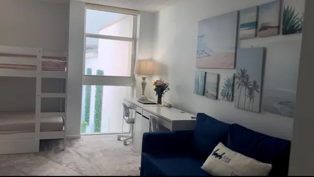 a room with gym equipment and a view of living room