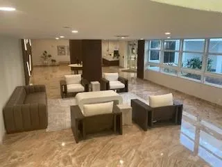 a living room with furniture and stairs