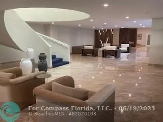 a view of living room with furniture and a large window