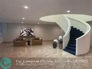 a living room with furniture and stairs