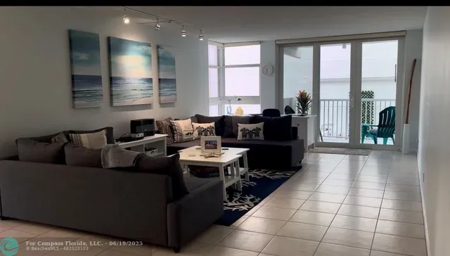 a living room with furniture and large windows