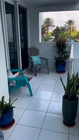 a view of a workspace with furniture and a potted plant