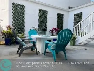 a work room with furniture and a potted plant