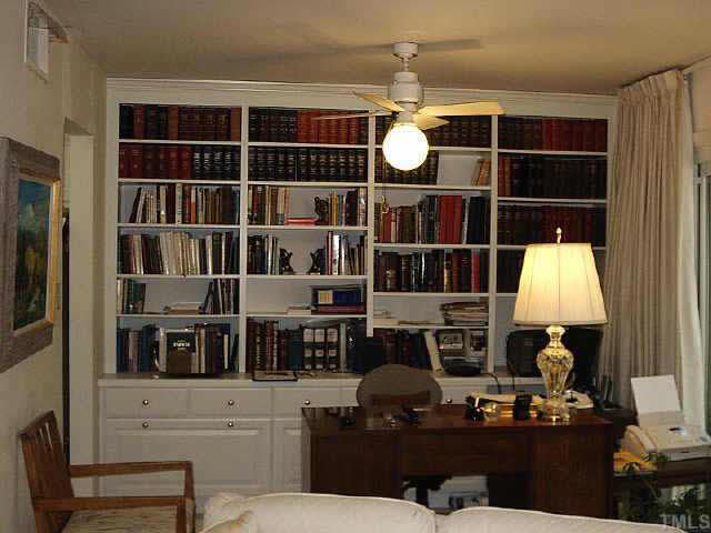 1786 Quail Ridge Road Raleigh, NC 27609 - Photo 7 of 10 a living room with furniture a lamp and a window